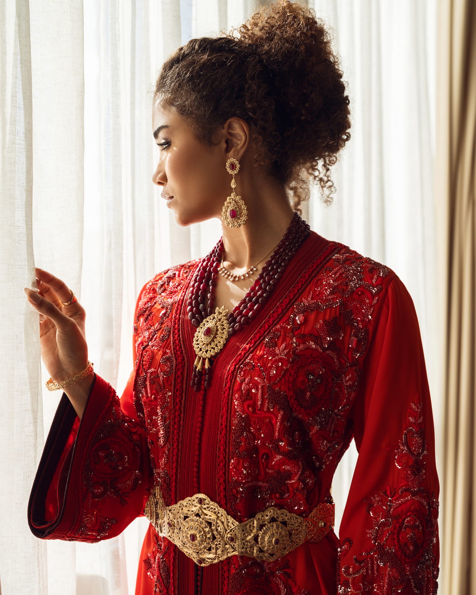 Deep ruby red couture Moroccan kaftan with gold embroidery and belt, front view