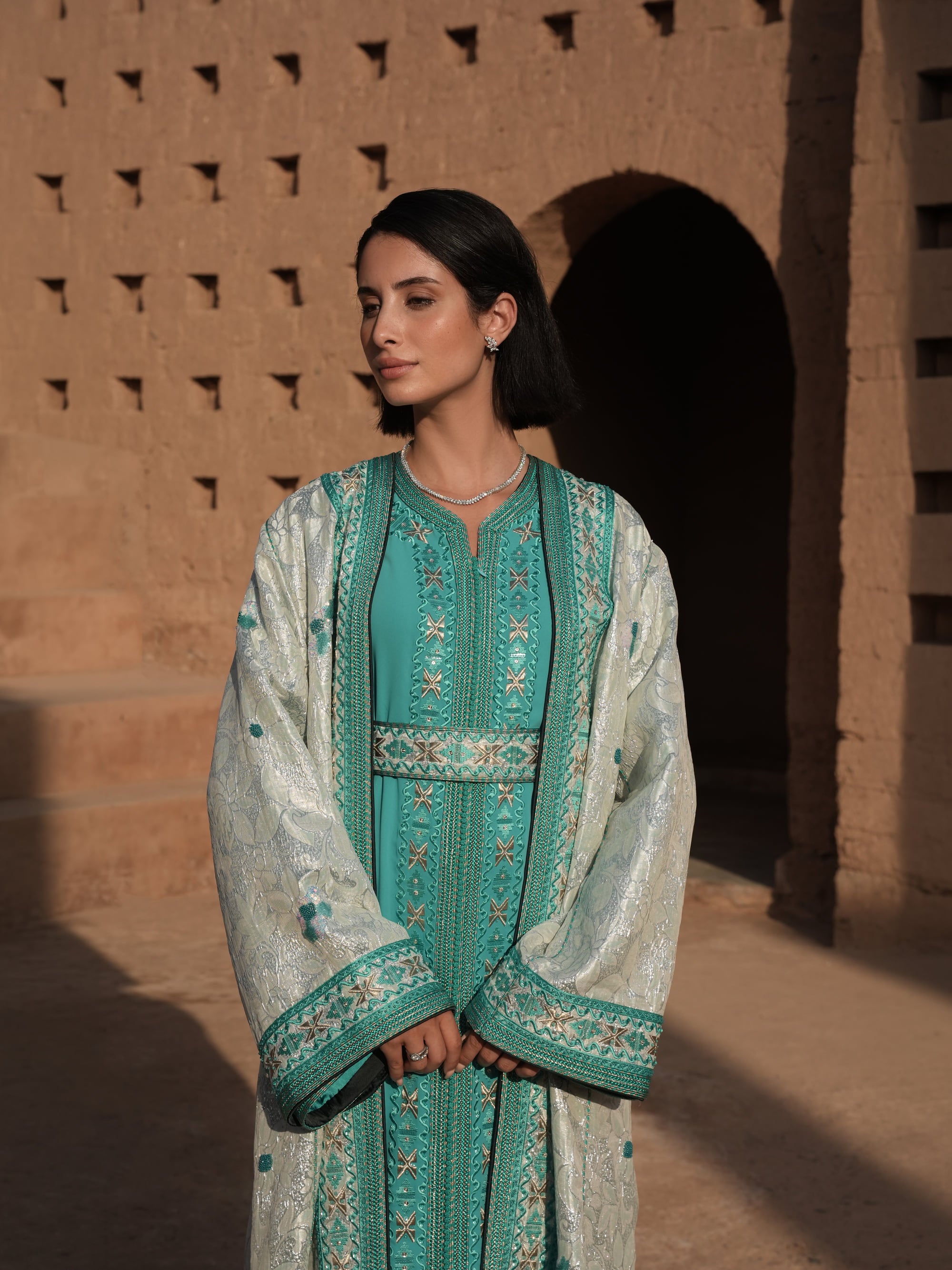 Azure Constellation turquoise Moroccan kaftan with star embroidery under an ivory brocade mansouria, full-length view