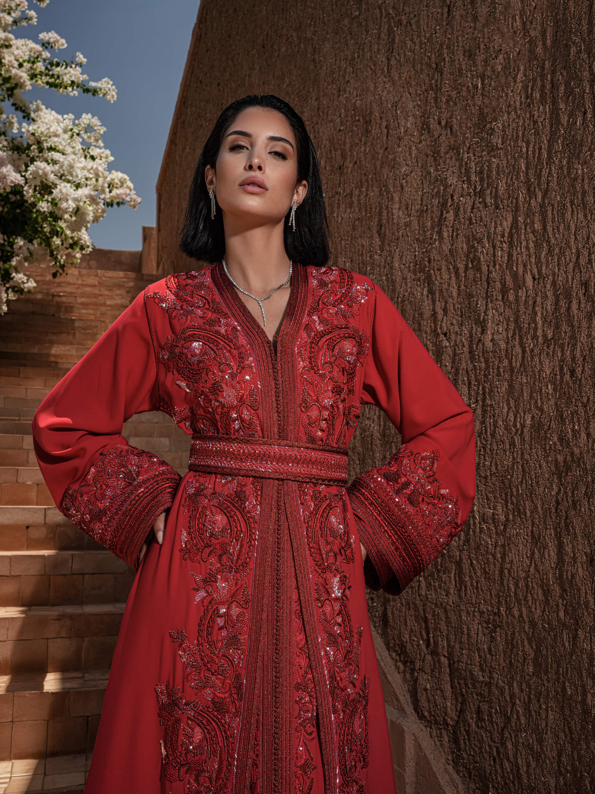 Carmine Cadence red crepe Moroccan kaftan with sequined paisley embroidery, braided belt and flared sleeves