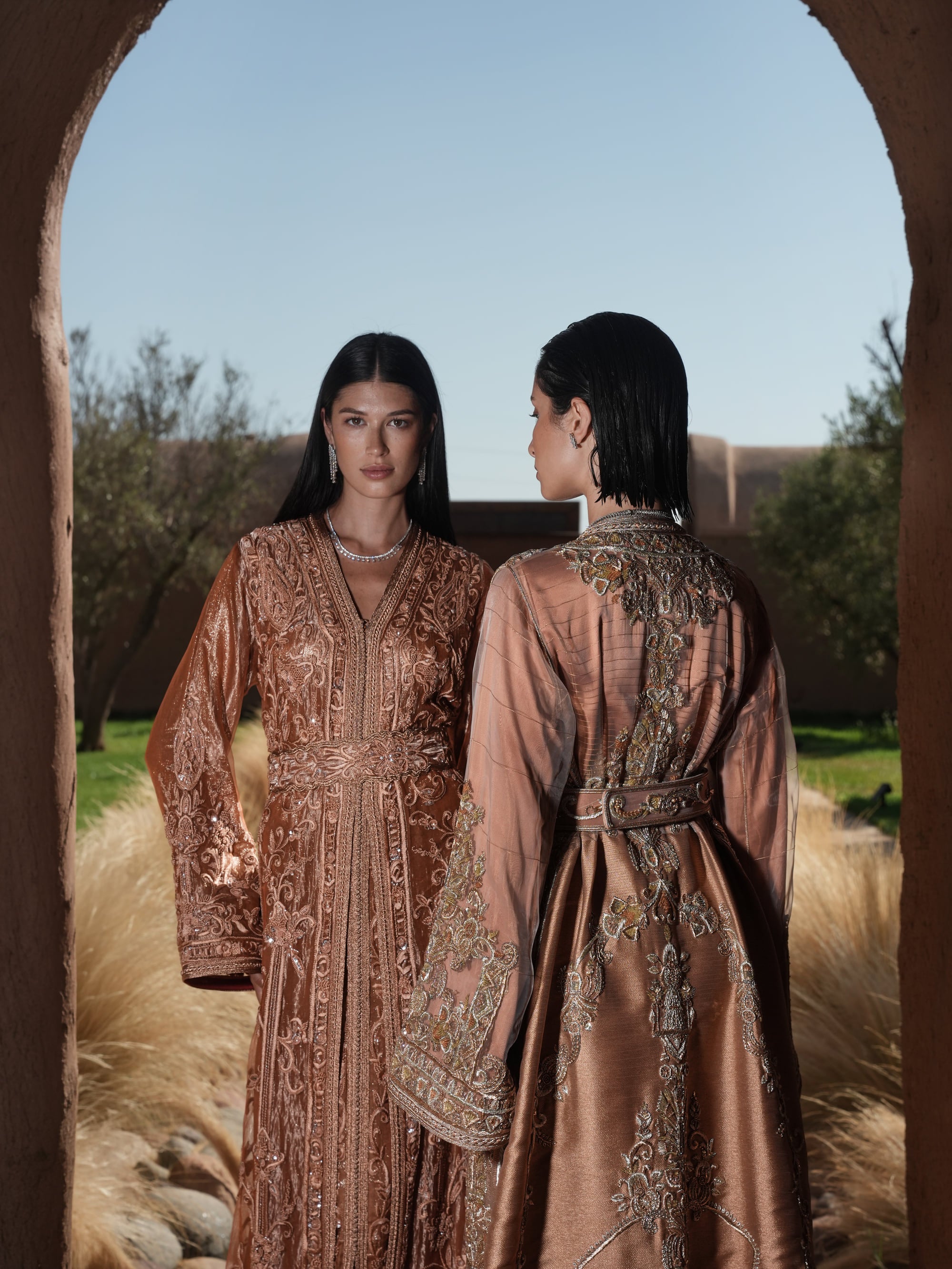 Copper Solstice devoré copper velvet Moroccan kaftan with tone-on-tone embroidery, shown alongside a second look