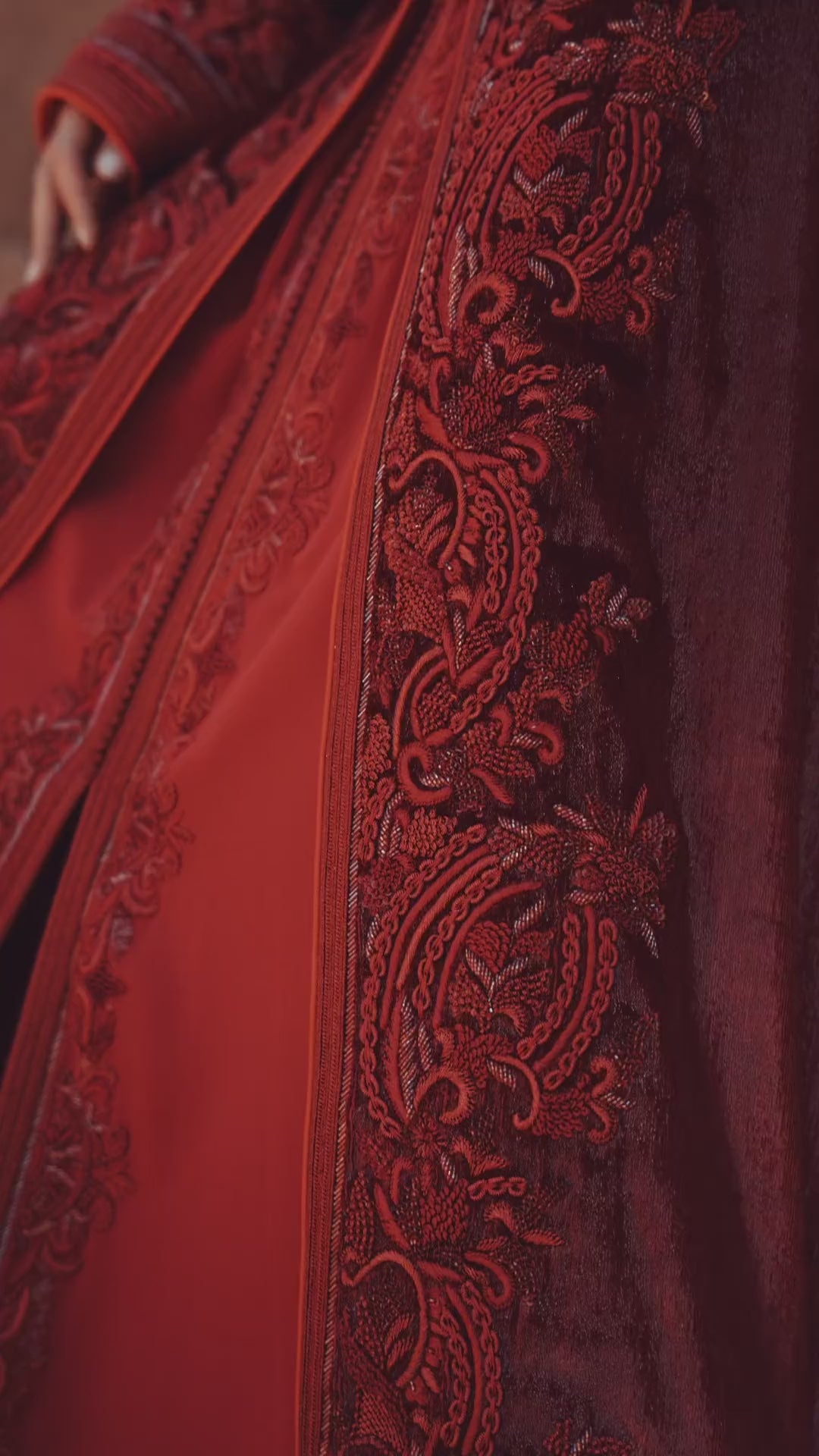 Garnet Adagio burgundy velvet Moroccan kaftan with tone-on-tone embroidery, matching belt and wide sleeves, in motion